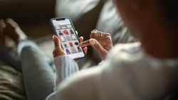 Woman purchasing clothes on a mobile app - stock photo